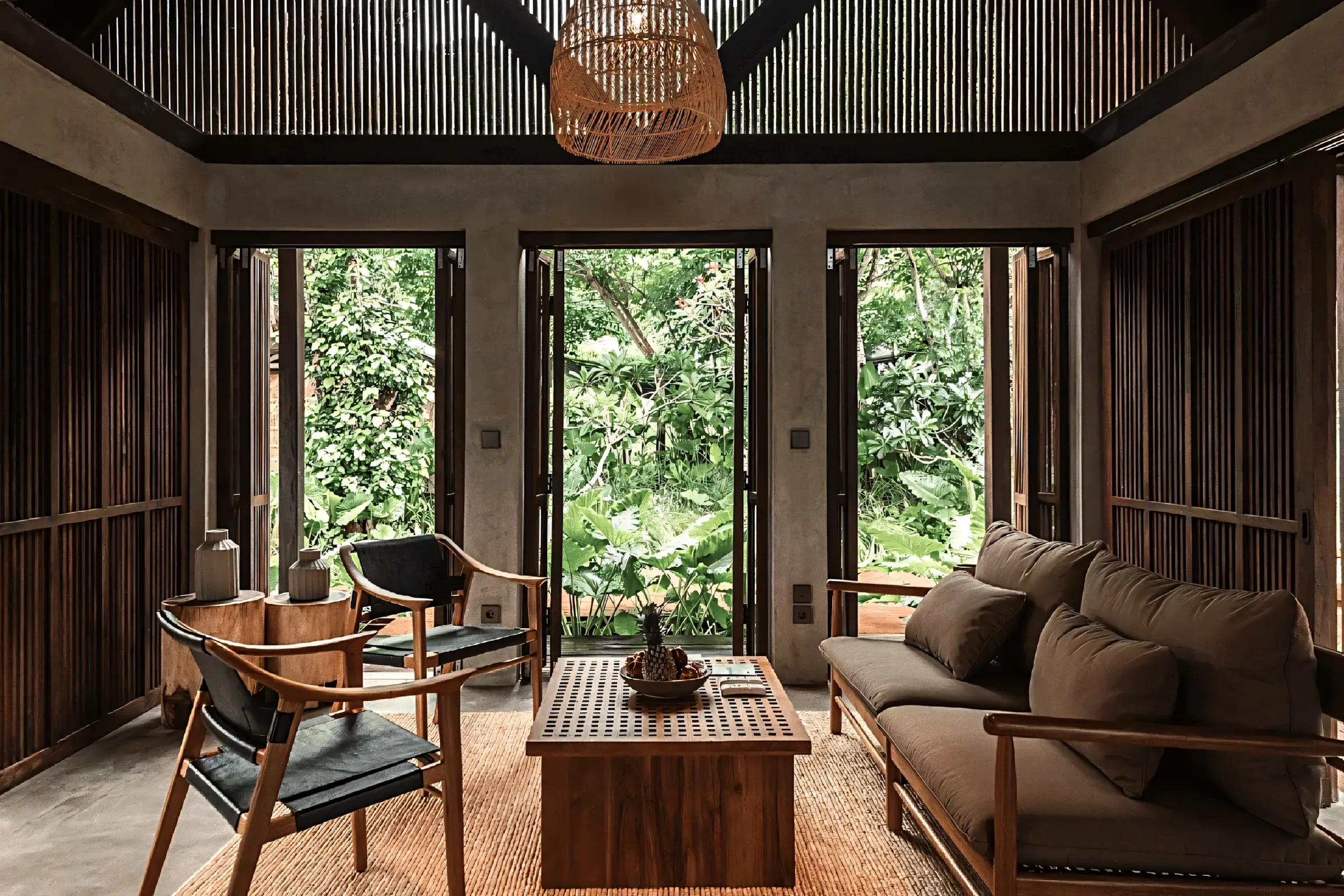 Living room of a private residence furnished with Yani's Gallery hand-carved teak and rattan pieces.