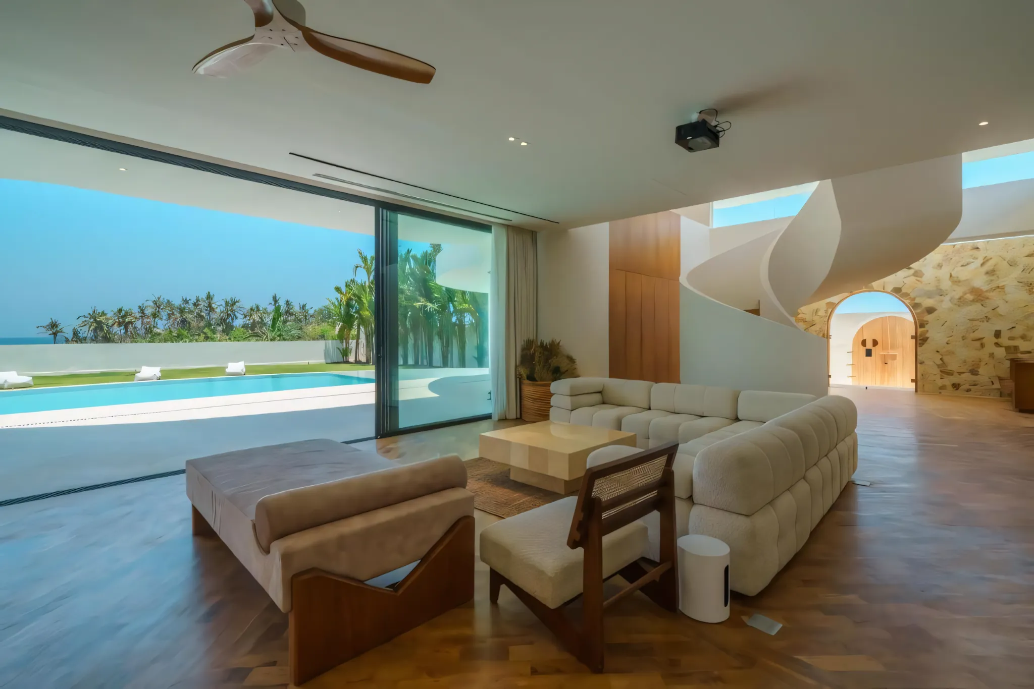 Living area opening onto the pool at Babylon Villa, Bali.